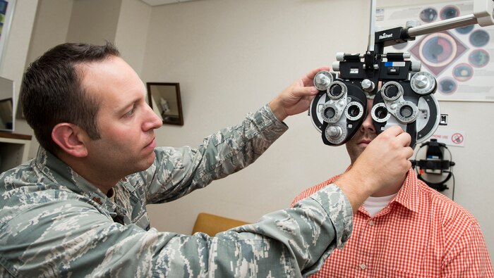 Maj. Peter Carra, 628th Medical Group optometry flight commander adjusts his optometry equipment Sep. 9, 2015, at the optometry office on Joint Base Charleston, S.C. The optometry clinic provides services such as eye examinations, visual acuity checks, repairing glasses, color vision tests and comprehensive exams. To set up an appointment, call the Air Base optometry clinic at 963-6880. (U.S. Air Force photo/Airman 1st Class Clayton Cupit)