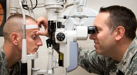 Maj. Peter Carra, 628th Medical Group Optometry flight commander, inspects the eyes of Tech. Sgt. Wesley Catoe, 628th MDG optometry NCOIC Sep. 9, 2015, at Joint Base Charleston – Air Base, S.C. The optometry office provides services such as eye examinations, visual acuity checks, repairing glasses, color vision tests and comprehensive exams. To set up an appointment, call the Air Base optometry clinic at 843-963-6880. (U.S. Air Force photo/Airman 1st Class Clayton Cupit)