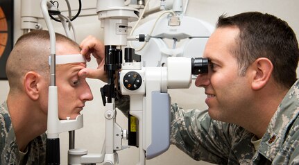 Maj. Peter Carra, 628th Medical Group optometry flight commander inspects the eyes of Tech. Sgt. Wesley Catoe, 628th MDG optometry NCOIC Sep. 9, 2015, at the optometry clinic on Joint Base Charleston, S.C. The optometry office provides services such as eye examinations, visual acuity checks, repairing glasses, color vision tests and comprehensive exams. To set up an appointment, call the Air Base optometry clinic at 963-6880. (U.S. Air Force photo/Airman 1st Class Clayton Cupit)