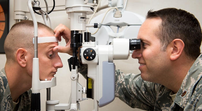 Maj. Peter Carra, 628th Medical Group optometry flight commander inspects the eyes of Tech. Sgt. Wesley Catoe, 628th MDG optometry NCOIC Sep. 9, 2015, at the optometry clinic on Joint Base Charleston, S.C. The optometry office provides services such as eye examinations, visual acuity checks, repairing glasses, color vision tests and comprehensive exams. To set up an appointment, call the Air Base optometry clinic at 963-6880. (U.S. Air Force photo/Airman 1st Class Clayton Cupit)