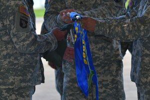 U.S. Army Training and Doctrine Command Flight Detachment leadership furl up the guidon during the detachment’s deactivation ceremony at Fort Eustis, Va., Sept. 8, 2015. The detachment activated in 1972 at Langley Air Force Base and was moved to Fort Eustis 10 years later. (U.S. Air Force photo by Staff Sgt. Natasha Stannard/Released)