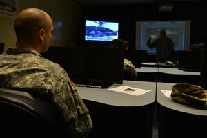 Members of the U.S. Army Public Health Command Fort Eustis Branch visit  Bravo Company, 1st Battalion, 210th Aviation Regiment, 128th Aviation Brigade as part of a partnership tour at Fort Eustis, Va., Sept. 3, 2015. Throughout the tour, the branch learned of the company’s training mission of providing advanced attack helicopter maintenance training in an environment that fosters resiliency and readiness. (U.S. Air Force photo by Staff Sgt. Natasha Stannard/Released)