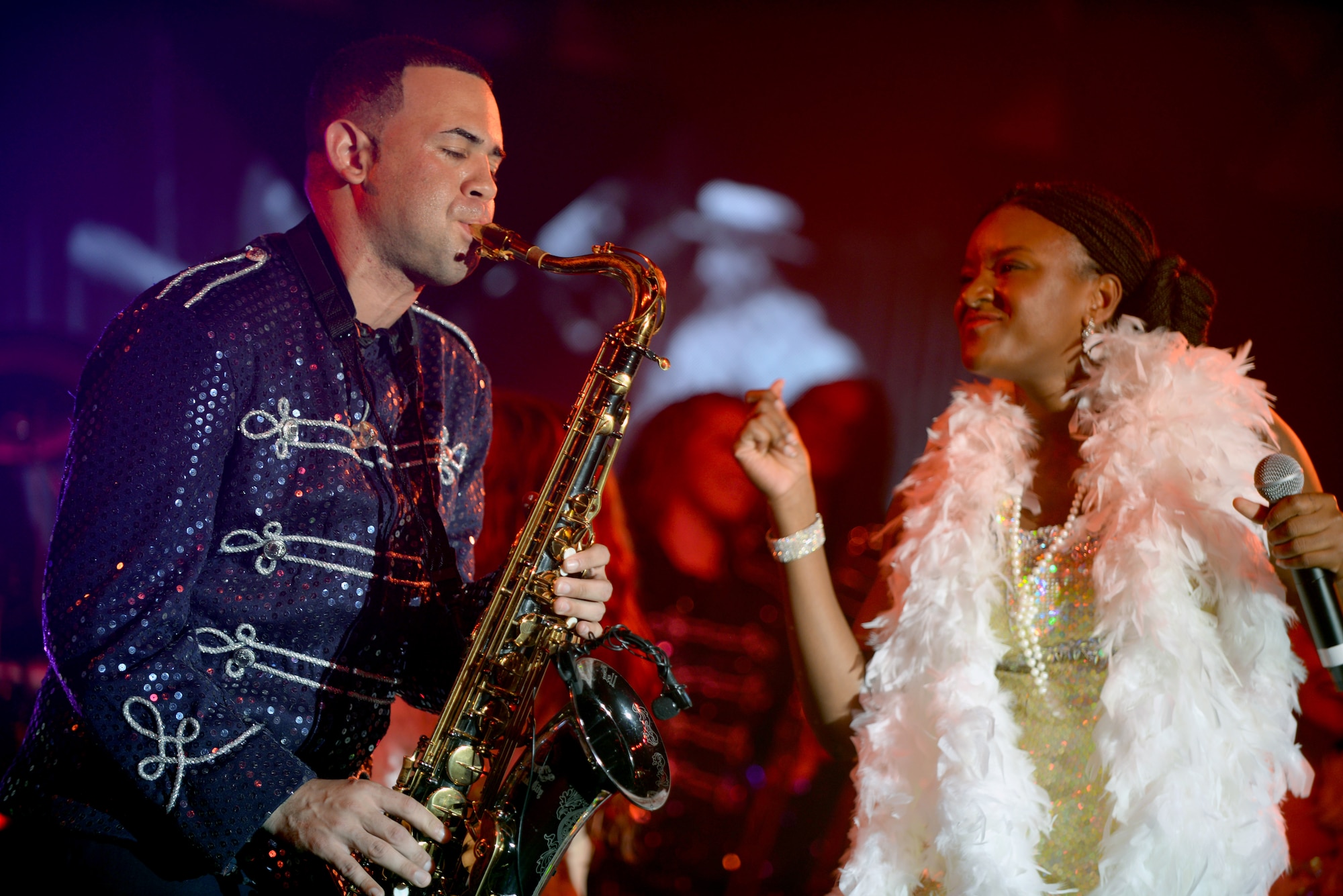 U.S. Air Force Senior Airman Javier Rodriguez, left, 100th Security Forces Squadron response force member, performs alongside U.S. Air Force Staff Sgt. Sherita Tisdom, Air Force Life Cycle Management Center medical system functional analyst from Maxwell-Gunter Air Force Base, Ala., during a Tops in Blue performance at the Northside Fitness Center Sept. 4, 2015, on RAF Mildenhall, England. Throughout the show, the performers wore a multitude of costumes matching era and genre of music they performed. (U.S. Air Force photo by Senior Airman Christine Halan/Released)