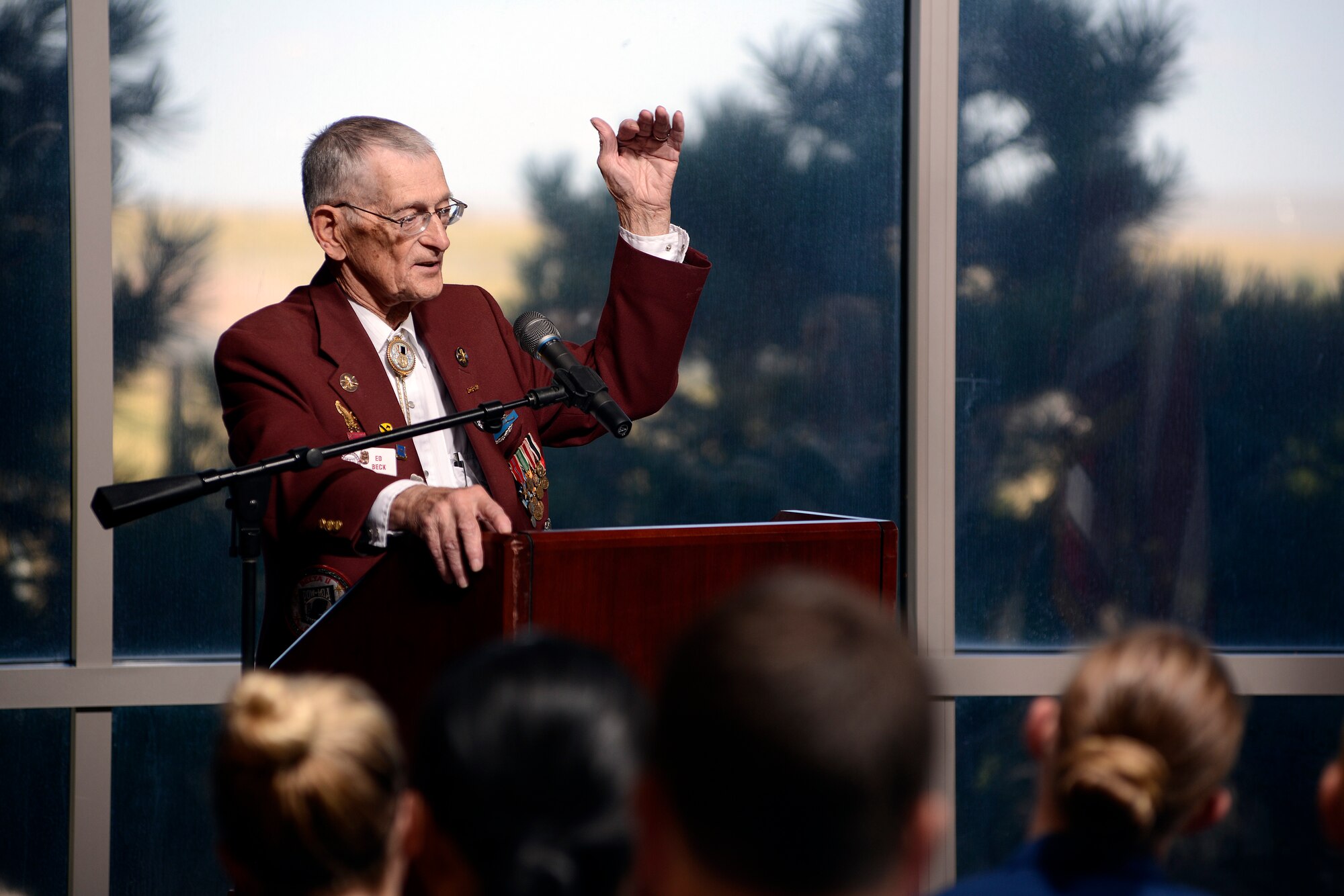 Retired U.S. Army Master Sgt. Ed beck speaks to Schriever members during the closing ceremony of POW/MIA remembrance week Sept. 18, 2014, at Schriever Air Force Base, Colorado. Beck was a POW during World War II and managed to escape after six months in captivity. (Air Force photo/Christopher DeWitt)