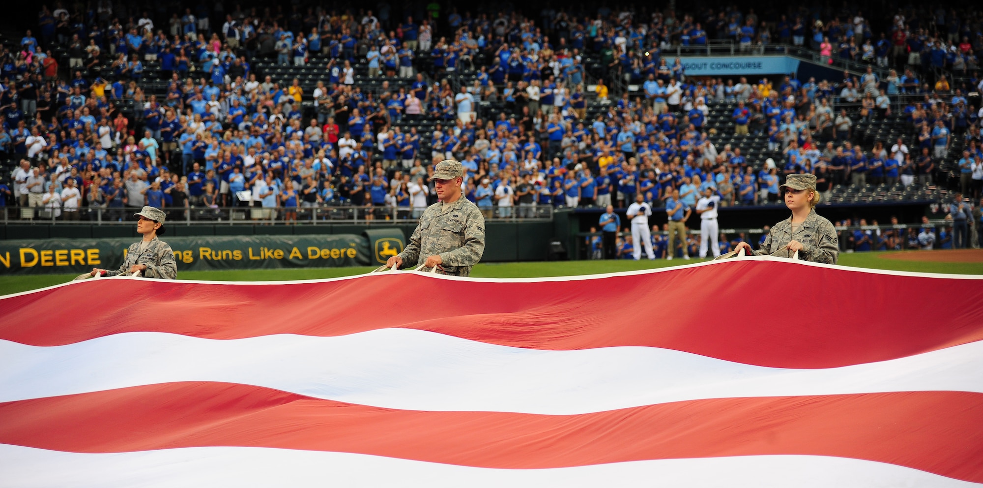 Airmen from Whiteman Air Force Base, Mo., hold a large flag during Armed Forces Night at Kauffman Stadium in Kansas City, Mo., Sept. 8, 2015. Airmen from Whiteman Air Force Base, Mo., performed the flag detail as part of the Kansas City Royals Armed Forces Night. (U.S. Air Force photo by Senior Airman Joel Pfiester/Released)