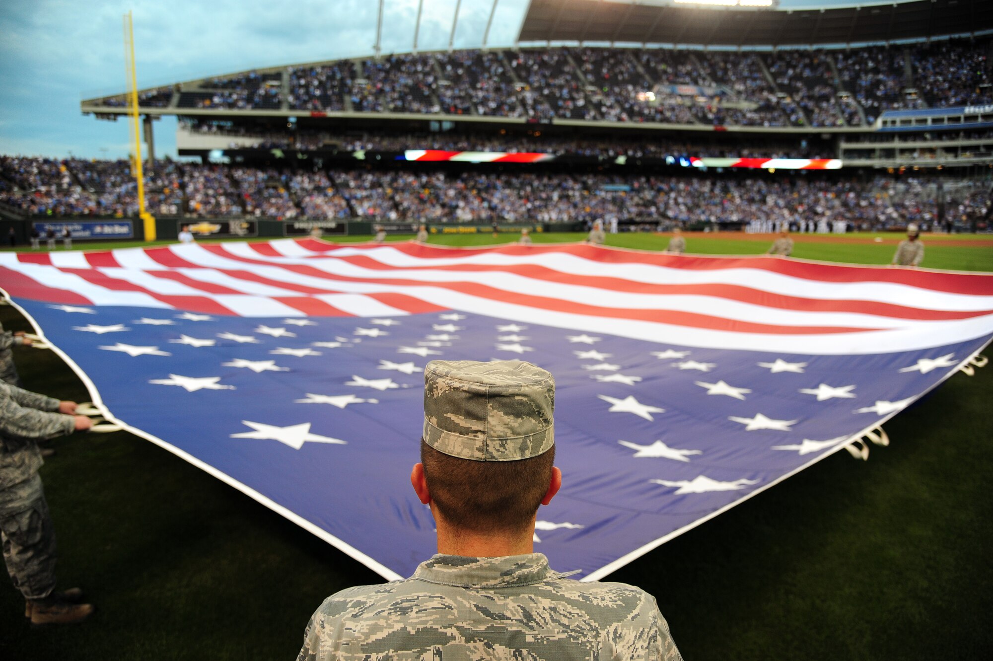 Airmen from Whiteman Air Force Base, Mo., perform a flag detail during Armed Forces Night at Kauffman Stadium in Kansas City, Mo., Sept. 8, 2015. The pregame ceremonies included a recognition of veterans, wounded warriors, military families, as well as a tribute to fallen service members. (U.S. Air Force photo by Senior Airman Joel Pfiester/Released)