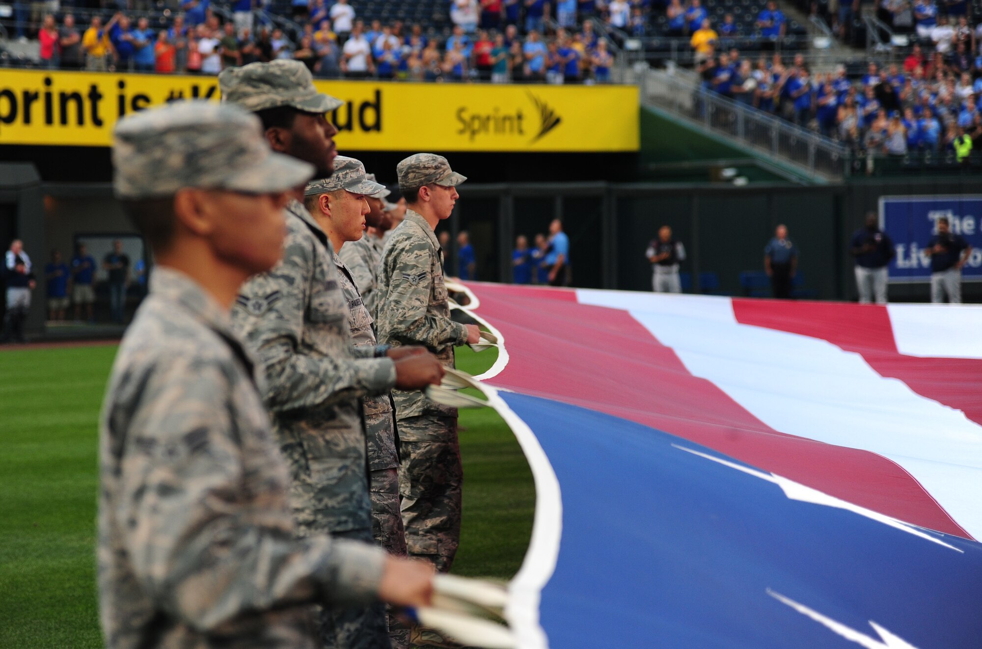 Airmen from Whiteman Air Force Base, Mo., perform a flag detail during Armed Forces Night at Kauffman Stadium in Kansas City, Mo., Sept. 8, 2015. The pregame ceremonies included a recognition of veterans, wounded warriors and military families, as well as a tribute to fallen service members. (U.S. Air Force photo by Senior Airman Joel Pfiester/Released)