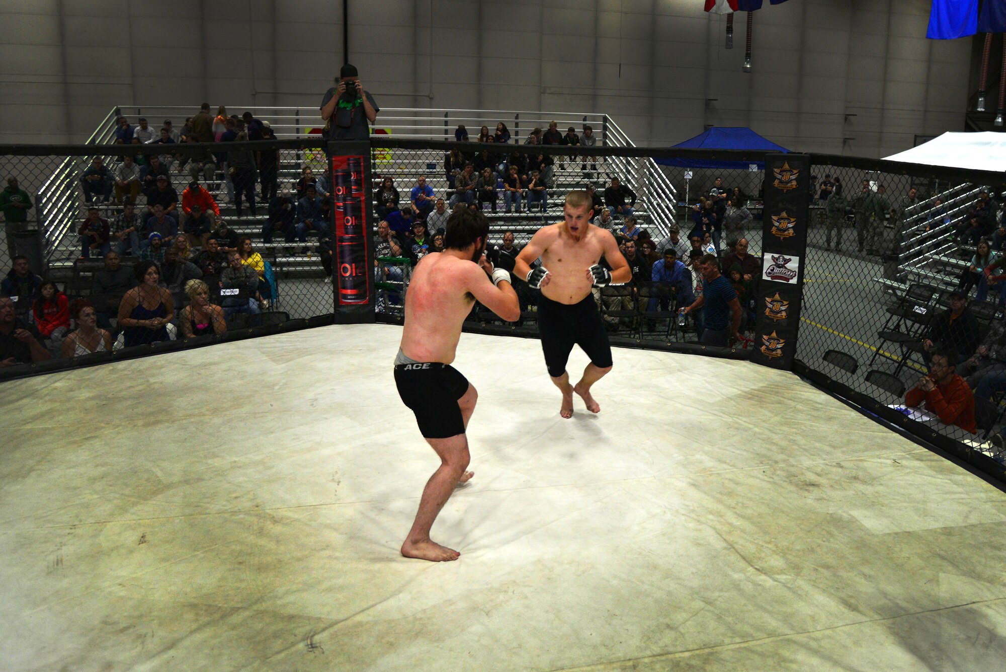 Mixed martial artists fight in front hundreds of Team Malmstrom members Aug. 4, 2015, at Malmstrom Air Force Base, Mont.  To kick off Labor Day weekend, the venue was free for all personnel with access to the base.  (U.S. Air Force photo/Airman Daniel Brosam)