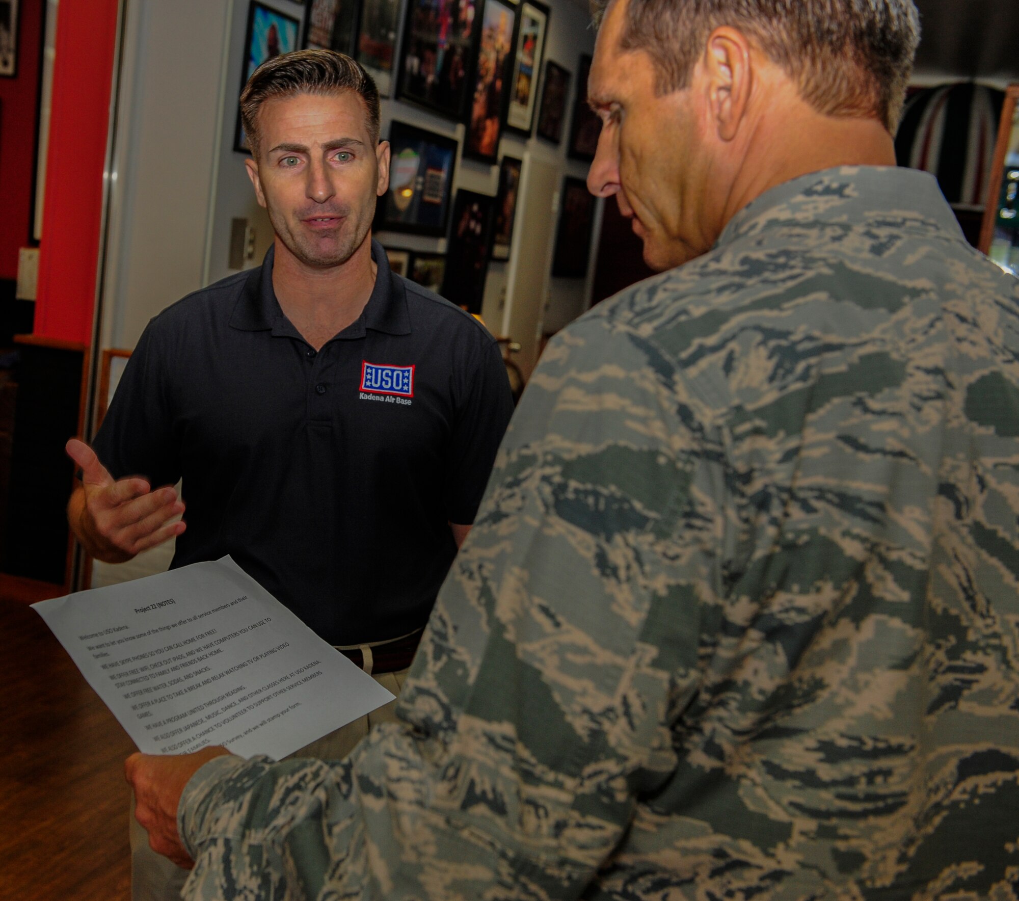 Brig. Gen. Barry Cornish, 18th Wing commander, talks with Brent Cook, center manager at the Kadena USO, about the programs the USO provides to service members and their families in support of Project 22, Sept. 9, 2015, at Kadena Air Base, Japan. The USO offers many resources to service members and their families to relax and feel welcome.  (U.S. Air Force Photo by Airman 1st Class Corey M. Pettis)
