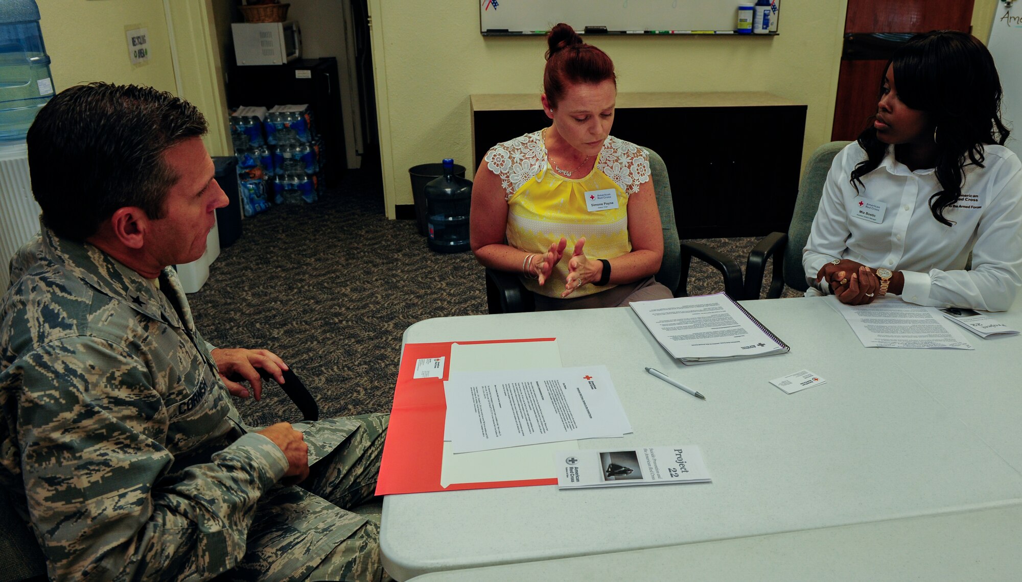 Brig. Gen Barry Cornish, 18th Wing commander, talks with Simone Payne, American Red Cross section chief (center), and Mia Bostic, American Red Cross assistant section manager (right), about the various services the American Red Cross provides to help support the Project 22 campaign, Sept. 9, 2015, at Kadena Air Base, Japan. Project 22 is a base-wide initiative challenging Airmen to visit agenecies that offer services to prevent suicide. (U.S. Air Force Photo by Airman 1st Class Corey M. Pettis)