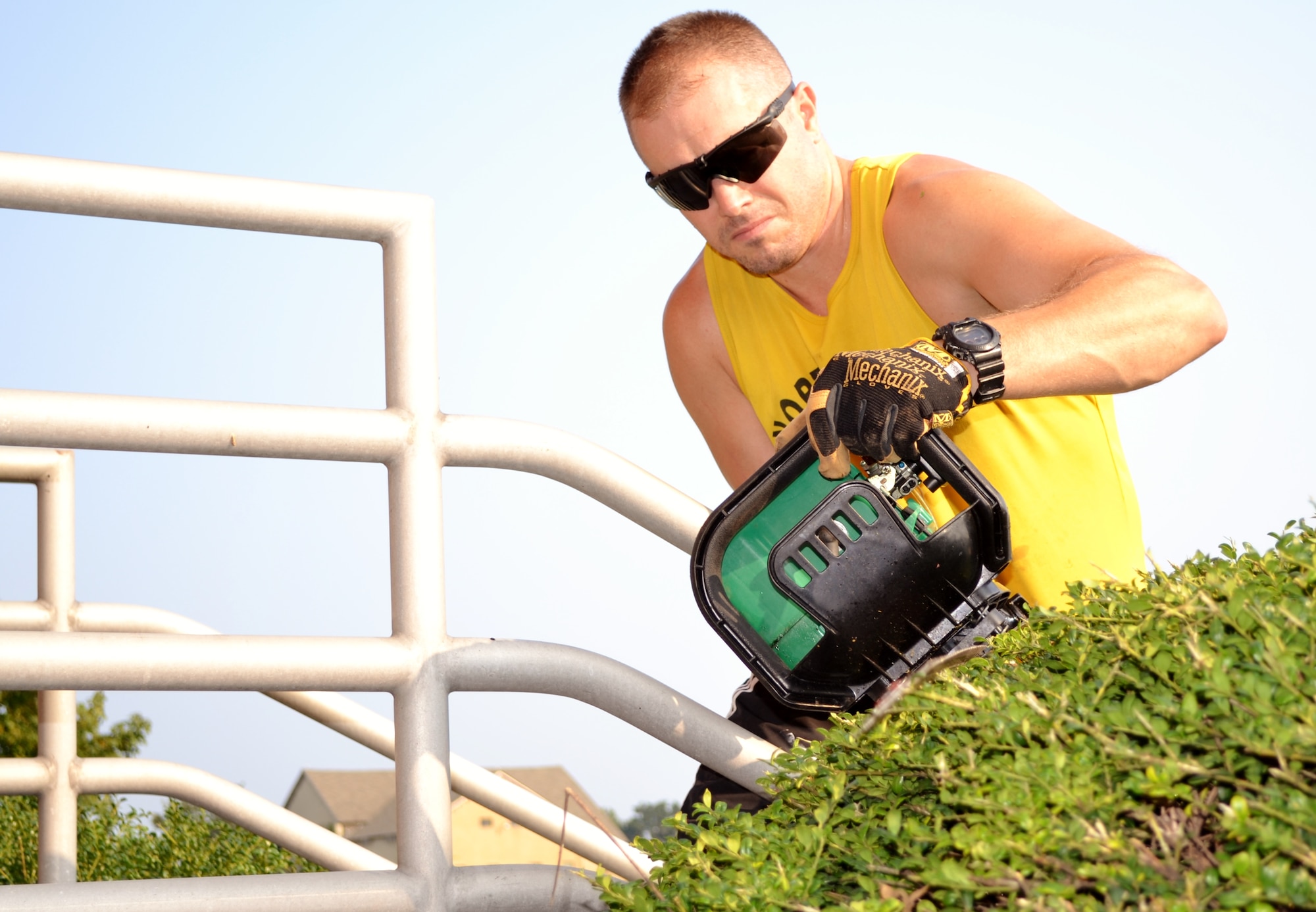 Master Sgt. Kevin Watson, 111th Attack Wing recruiting office supervisor, uses a hedge trimmer to cut back shrubs that surround the Wing’s headquarters building, Aug. 4, 2015, Horsham Air Guard Station, Pennsylvania. Watson used his landscaping skills during the wing’s clean-up day. (U.S. Air National Guard photo by Tech. Sgt. Andria Allmond/Released)