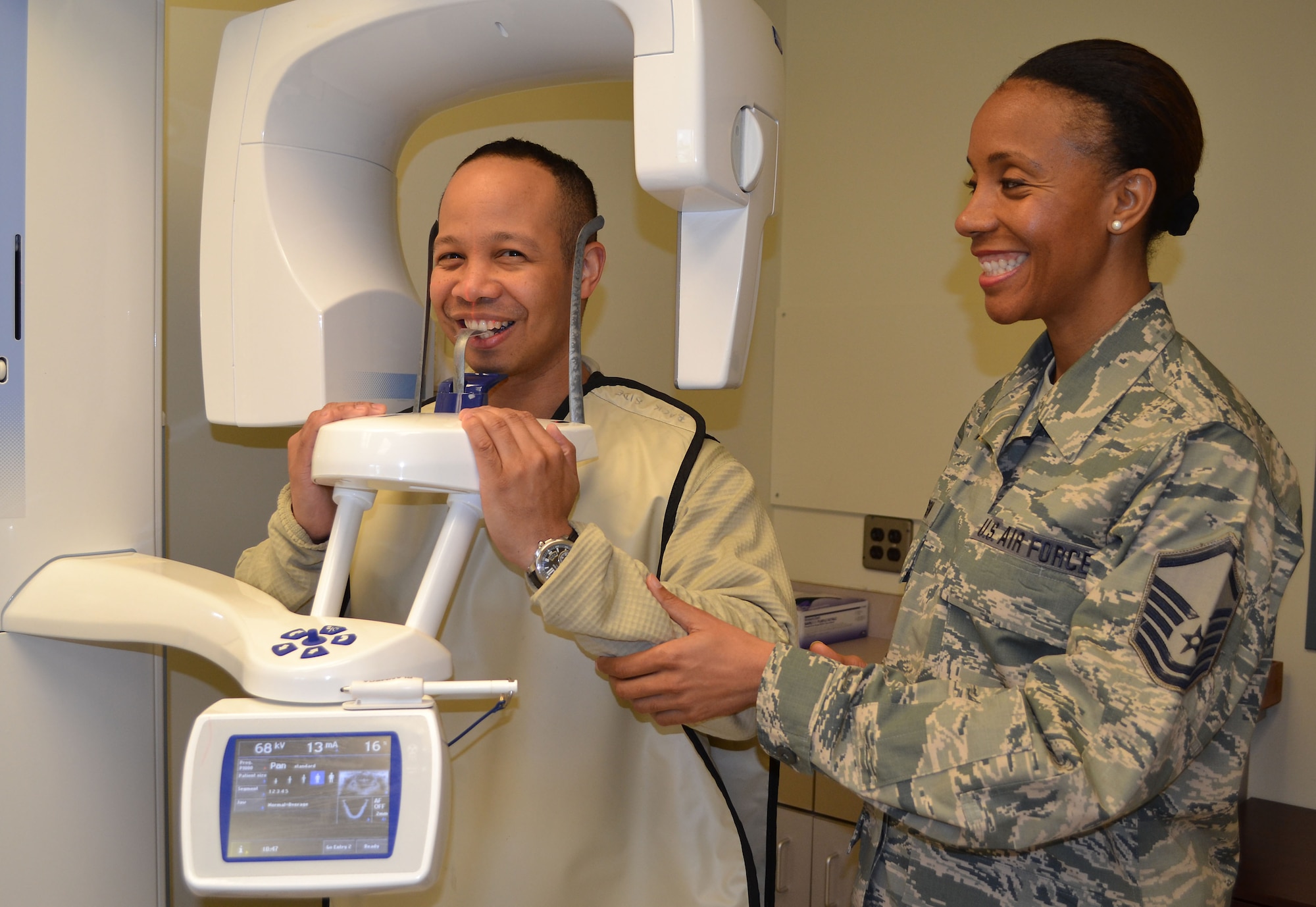 Master Sgt. Alexis Morrison, 111th Attack Wing Non-commissioned officer in charge of the dental clinic, positions Master Sgt. Roberto Brabham, 111th ATKW Medical Group, in the panoramic radiograph unit April 4, 2015 at the Horsham Air Guard Station dental clinic. The dental staff will take dental radiographs, as needed, to accomplish Wing members' yearly dental exam requirement. (U.S. Air National Guard photo by Tech. Sgt. Andria Allmond/Released)