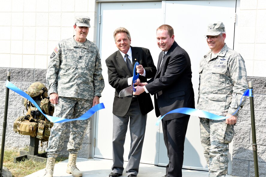 Pennsylvania Adjutant General Maj. Gen. James Joseph, left, Pennsylvania State Representative Russ Diamond, Lebanon County Coordinator Brian Craig and Deputy Adjutant General - Air, Brig. Gen. Tony Carrelli cut the ribbon at a ribbon cutting ceremony and demonstration at Fort Indiantown Gap, Pennsylvania, Sept. 2, 2015. The ceremony highlighted the Pennsylvania National Guard’s 148th ASOS’s new Air National Guard Advanced Joint Terminal Attack Controller Training Simulator Building. The simulator helps Airmen develop the solid fundamentals necessary to become tomorrow’s Battlefield Airmen and keep their present Joint Terminal Attack Controllers current in their air control requirements.

The simulator is also a joint readiness tool for their Army National Guard counterparts. Together, they will now be able to conduct more realistic Joint fires Observer training; allowing qualified enlisted and junior officers to conduct Calls for Fire in a complex battlespace. They can also train joint forces in MedEvac 9-lines and emergency close air support which will aid in the capability development for their aligned Army units.   

This simulator is truly a force multiplier for both the Pennsylvania Army and Air National Guard. (U.S. Air National Guard photo by Master Sgt. Culeen Shaffer/Released)
