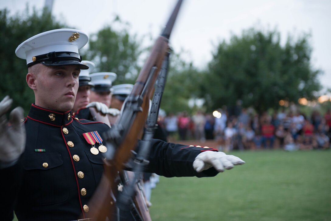 A Marine from the United States Marine Corps Silent Drill Platoon preforms a series of rifle maneuvers at Civic Space Park, Phoenix, Sept. 9, 2015, as part of the opening ceremony for Marine Week Phoenix. Marine Week Phoenix allows the local community to see the Marine Corps in a way that they would not normally be able to experience. 