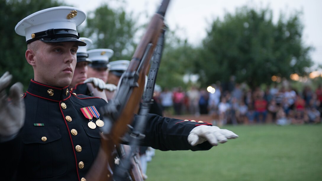 A Marine from the United States Marine Corps Silent Drill Platoon preforms a series of rifle maneuvers at Civic Space Park, Phoenix, Sept. 9, 2015, as part of the opening ceremony for Marine Week Phoenix. Marine Week Phoenix allows the local community to see the Marine Corps in a way that they would not normally be able to experience.