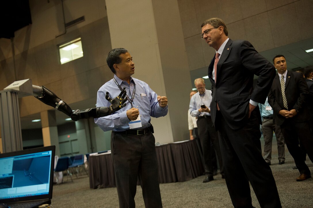 Defense Secretary Ash Carter, right, is briefed on the robotic limb exhibit at the Defense Advanced Research Projects Agency “Wait, What?" future technology forum at the America's Convention Center Complex in St. Louis, Mo., Sept. 9, 2015. DoD photo by U.S. Air Force Senior Master Sgt. Adrian Cadiz 
