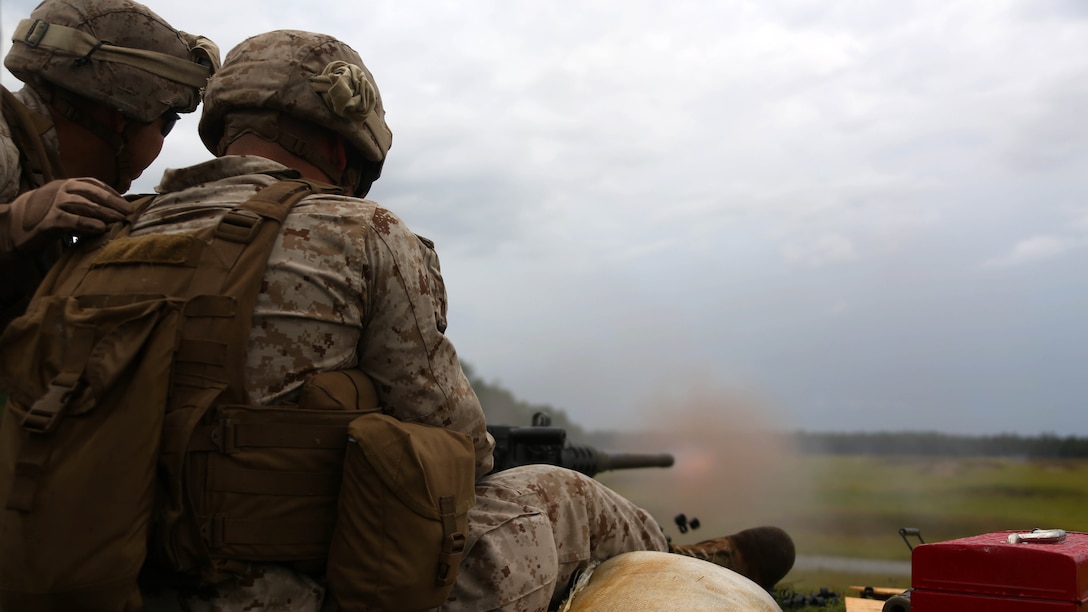 Sgt. David Sosa, left, assists Cpl. Gerardo Lopez Ortiz with firing a Browning M2 .50-caliber machine gun down range during a weapons familiarization range at Marine Corps Base Camp Lejeune, North Carolina, Aug. 27, 2015. More than 100 Marines from Marine Air Support Squadron 1 honed their weapons skills with the M240B machinegun, Browning M2 .50-caliber machine gun and the M1014 combat shotgun. Marines from various military job occupations received hands-on experience that allows them to improve crucial skills and become well-rounded war fighters. Sosa and Ortiz are air support operations operators with MASS-1.