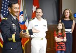 Maj. Gen. K.K. Chinn (left), U.S. Army South commanding general, speaks to members of the command during the promotion ceremony for Navy Capt. Charles Koutras, a Department of the Army civilian assigned to the Judge Advocate Office at Army South, while Koutras’ family watches at the command’s headquarters on Fort Sam Houston Sept. 3. 