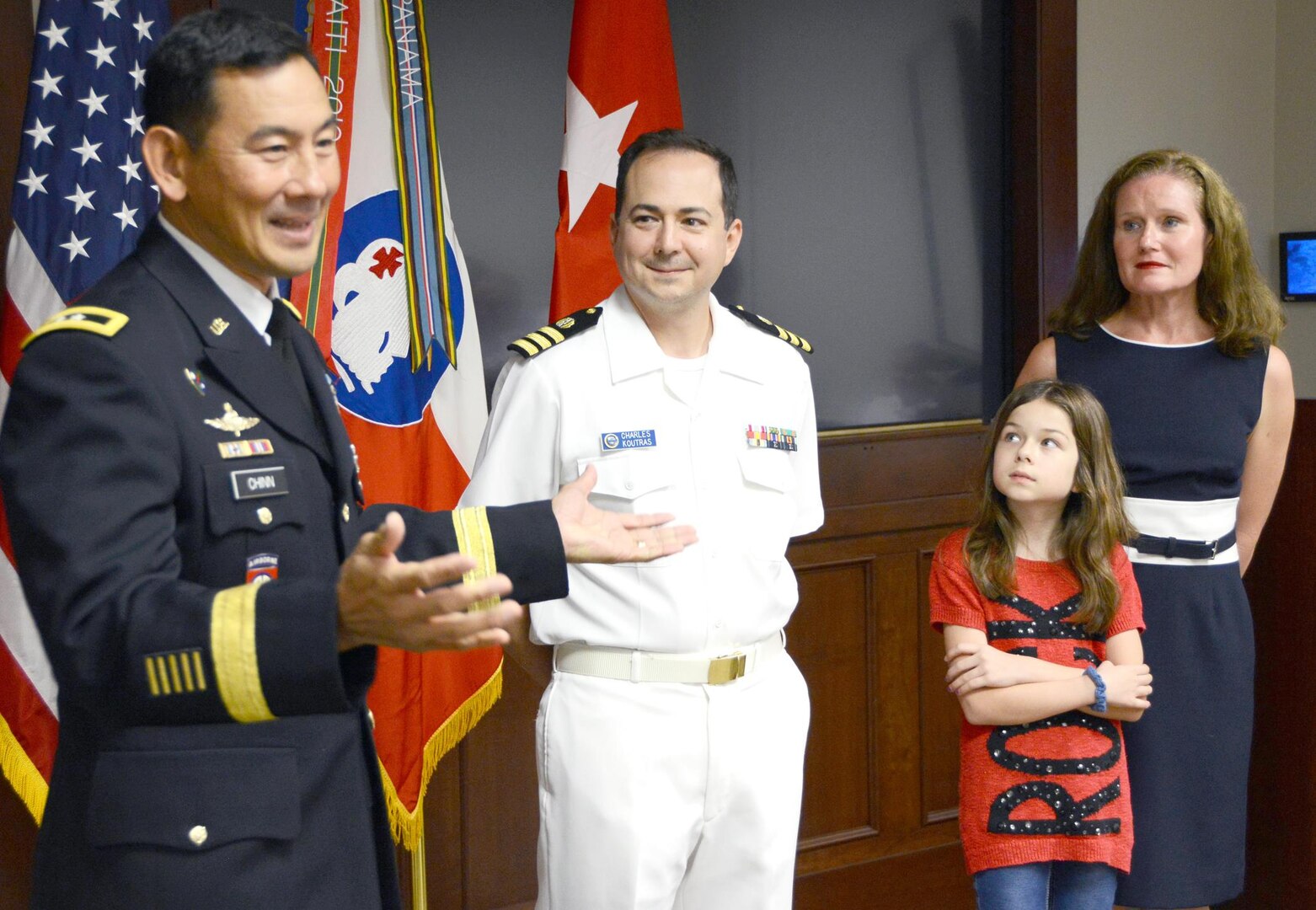 Maj. Gen. K.K. Chinn (left), U.S. Army South commanding general, speaks to members of the command during the promotion ceremony for Navy Capt. Charles Koutras, a Department of the Army civilian assigned to the Judge Advocate Office at Army South, while Koutras’ family watches at the command’s headquarters on Fort Sam Houston Sept. 3. 
