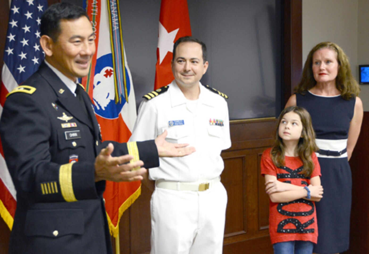 Maj. Gen. K.K. Chinn (left), U.S. Army South commanding general, speaks to members of the command during the promotion ceremony for Navy Capt. Charles Koutras, a Department of the Army civilian assigned to the Judge Advocate Office at Army South, while Koutras’ family watches at the command’s headquarters on Fort Sam Houston Sept. 3. 
