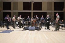 On Sept. 8, 2015, Chairman of the Joint Chiefs Gen. Martin Dempsey and the Irish folk-group the High Kings joined the Marine Band's Irish ensemble for a jam session in the John Philip Sousa Band Hall at the Marine Barracks Annex in Washington, D.C. The visit also included a tour of the building, led by Marine Band Director Lt. Col. Jason Fettig. (U.S. Marine Corps photo by Master Sgt. Kristin duBois/released)