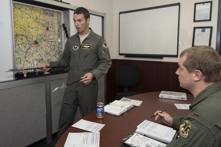 Maj. Jason Bianchi, 12th Operations Group executive officer, gives 2nd Lt. Duston Obrien, 435th Fighter Training Squadron upgrade pilot, a pre-flight briefing Sept. 3, 2015, at Joint Base San Antonio-Randolph. The 435th Fighter Training Squadron conducts Introduction to Fighter Fundamentals student training in nearly 50 T-38C Talon aircraft and trains IFF instructors for Air Education and Training Command at large. The 435th FTS trains approximately 150 students annually from the United States, Iraq, Japan, Poland, Saudi Arabia, and Singapore.