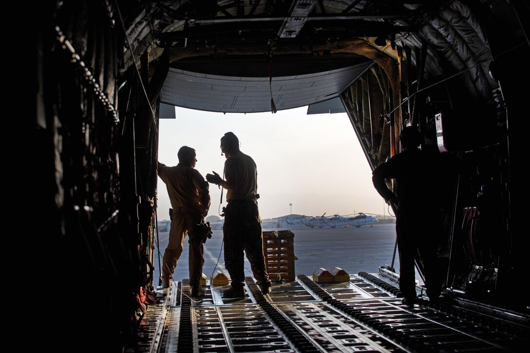 U.S. airmen talk before loading cargo onto an Air Force C-130J Super Hercules aircraft at Mazar-e Sharif Airfield, Afghanistan, Aug. 27, 2015. U.S. Air Force photo by Tech. Sgt. Joseph Swafford