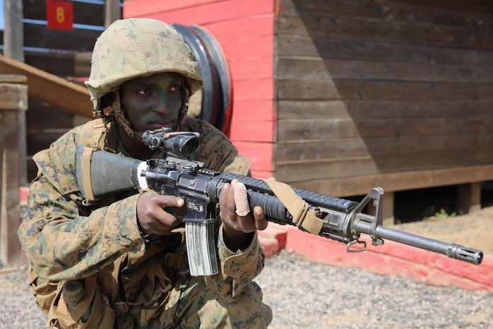 Private Chris M. Gitau, Golf Company, 2nd Recruit Training Battalion, provides security for his squad during the Crucible 12 Stalls event at Edson Range, Camp Pendleton, Calif., Sept. 2.  During the Crucible event, if a Marine was not actively participating in the obstacle, he was required to provide security to simulate a real combat scenario.  Gitau grew up in Nairobi, Kenya, before moving to America at the age of 21 for broader opportunities to experience.  Today, all males recruited from west of the Mississippi are trained at MCRD San Diego. The depot is responsible for training more than 16,000 recruits annually. Golf Company graduated Sept. 11.