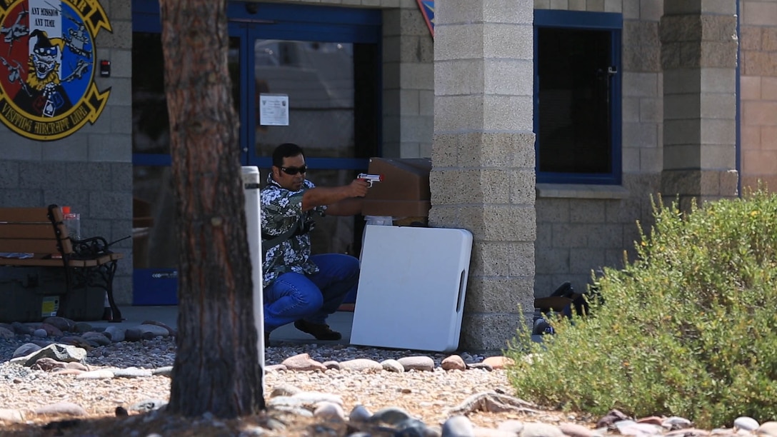 An active shooter response exercise participant simulates firing a handgun during an active shooter response exercise at Marine Corps Air Station Miramar, California, Sept. 2. The station also participated in an aircraft mishap response exercise the next day as part of required annual safety training for the installation.