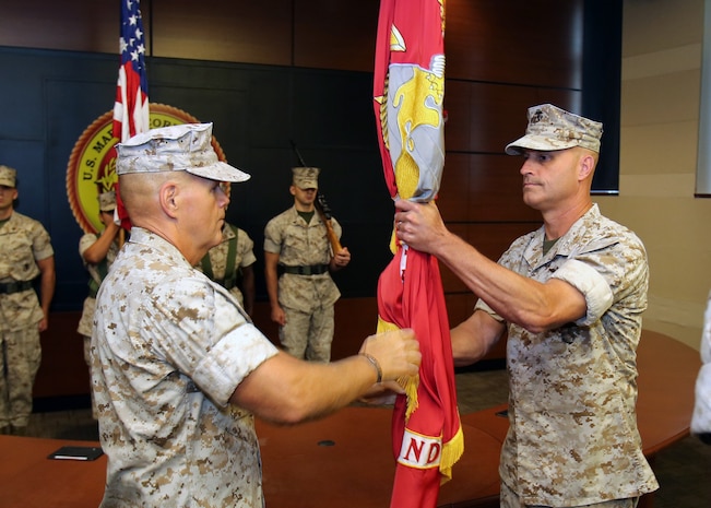 Lt. Gen. Robert Neller (left), outgoing commander of U.S. Marine Corps Forces Command, passes the organizational colors to Brig. Gen. (select) Bradford Gering (right) during a succession-of-command ceremony aboard Naval Support Activity Hampton Roads in Norfolk, Va., on Sept. 10, 2015. Neller is scheduled to become the 37th commandant of the Marine Corps later this month. (Marine Corps photo by Steve Kotecki)