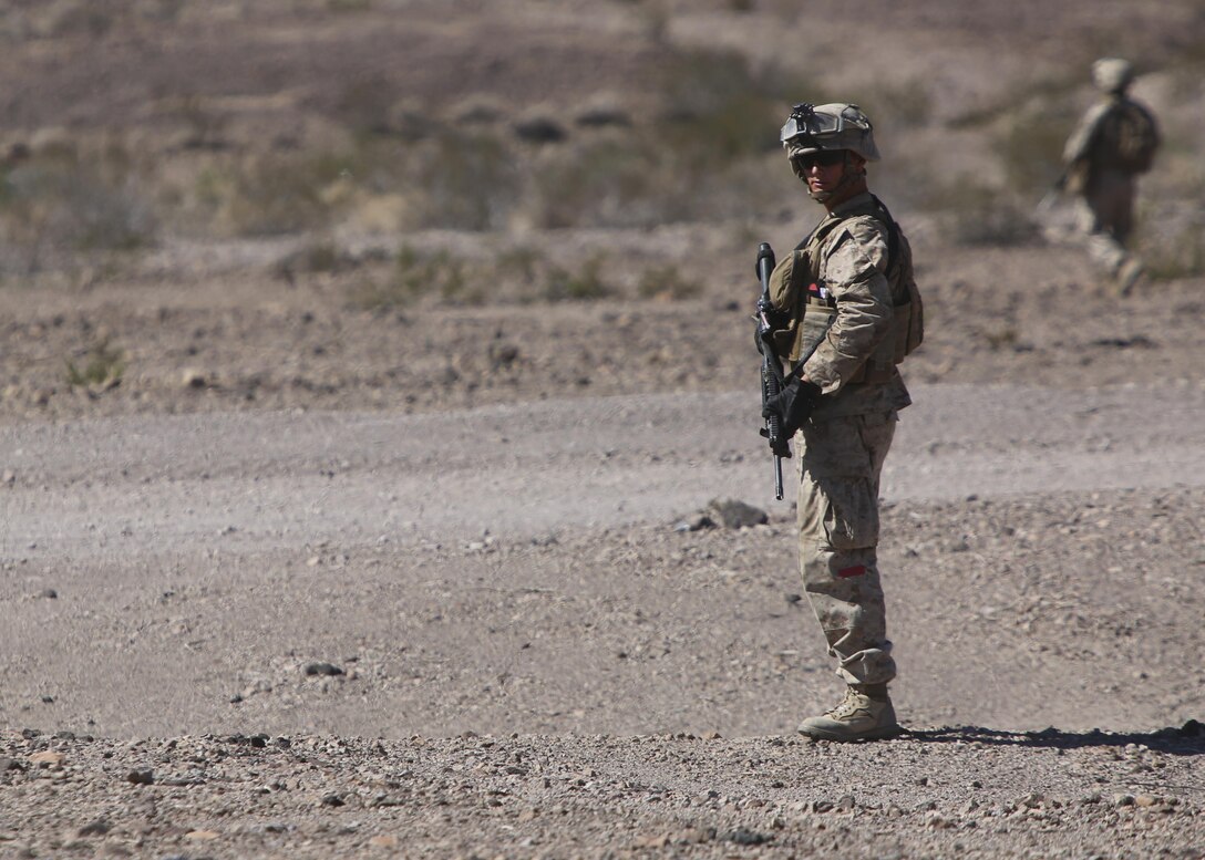 Lance Cpl. Dakota Miller, a landing support specialist with Combat Logistics Battalion 1, Combat Logistics Regiment 1, 1st Marine Logistics Group, scans the area for debris while clearing a landing zone during a simulated casualty evacuation aboard Marine Corps Air Ground Combat Center Twentynine Palms, California, Aug. 10, 2015. After a simulated improvised explosive device attack, Marines had to move two wounded Marines from a downed vehicle to a safe area and call for air support to assist the evacuation.