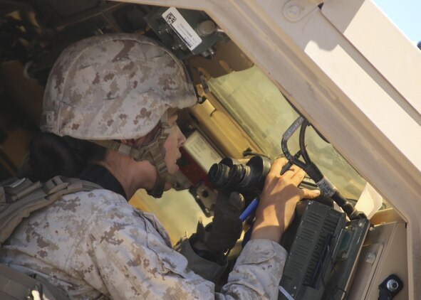 1st Lt. Isabel Marin, a logistics officer with Combat Logistics Battalion 1, Combat Logistics Regiment 1, 1st Marine Logistics Group, watches for artillery strikes after calling for fire support during a mounted patrol exercise aboard Marine Corps Air Ground Combat Center Twentynine Palms, California, Aug. 10, 2015. Marines responded to simulated ambushes with live machine gun, rocket and artillery fire.