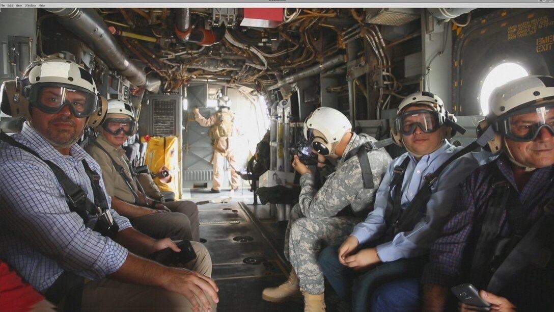 Community leaders and Arizona government officials (from left to right: Jason Rowley with the Phoenix Suns, Timothy Day of Bar S Foods, Rep. Jonathan Larkin and Rep. Sonny Borrelli) observe the view of the city of Phoenix from an MV-22B Osprey, Sept. 9, 2015, during Marine Week Phoenix. Marine Week Phoenix is an opportunity for the people of the greater Phoenix area to meet Marines and learn about Corps history, traditions, and value to the nation. (USMC photo by Pfc. Devan Gowans/Released)