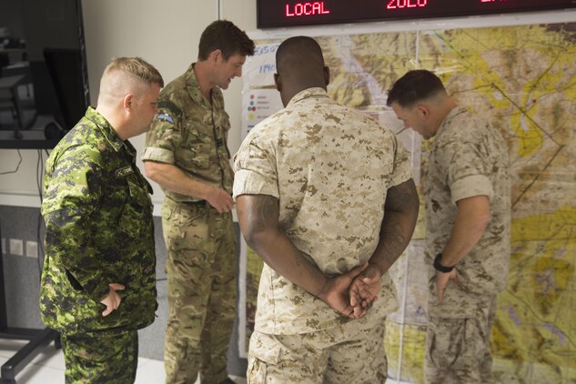 Marines with 2nd Marine Expeditionary Brigade and service members with the 1 Canadian Mechanized Brigade Group and British 3 Commando Brigade review a scenario during Atlantic Response 15.4 aboard Marine Corps Base Camp Lejeune, N.C., July 23, 2015. Atlantic Response 15.4 was a mission rehearsal, which allowed U.S. Marine, Canadian and British forces to prepare for Large Scale Exercise 15, a combined exercise conducted at the brigade level, designed to enable live, virtual and constructive training for participating forces.