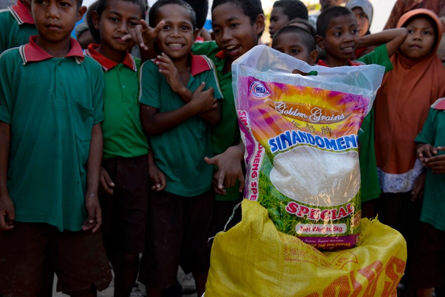 Students of the Al-Amal primary school gather during a rice donation to the neighbouring orphanage Sept. 8, 2015, in Baucau, Timor-Leste. Efforts undertaken during Pacific Angel help multilateral militaries in the Pacific improve and build relationships across a wide spectrum of civic operations, which bolsters each nation’s capacity to respond and support future humanitarian assistance and disaster relief operations. (U.S. Air Force photo/Staff Sgt. Alexander W. Riedel/Released)