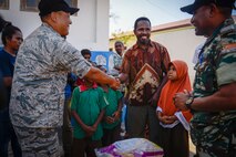Lt. Col. Edward Khim, Pacific Angel  15-2 commander, left, shakes hands with the head administrator of the Al-Amal orphanage during a rice donation Sept. 8, 2015, in Baucau, Timor-Leste. Efforts undertaken during Pacific Angel help multilateral militaries in the Pacific improve and build relationships across a wide spectrum of civic operations, which bolsters each nation’s capacity to respond and support future humanitarian assistance and disaster relief operations. (U.S. Air Force photo/Staff Sgt. Alexander W. Riedel/Released)