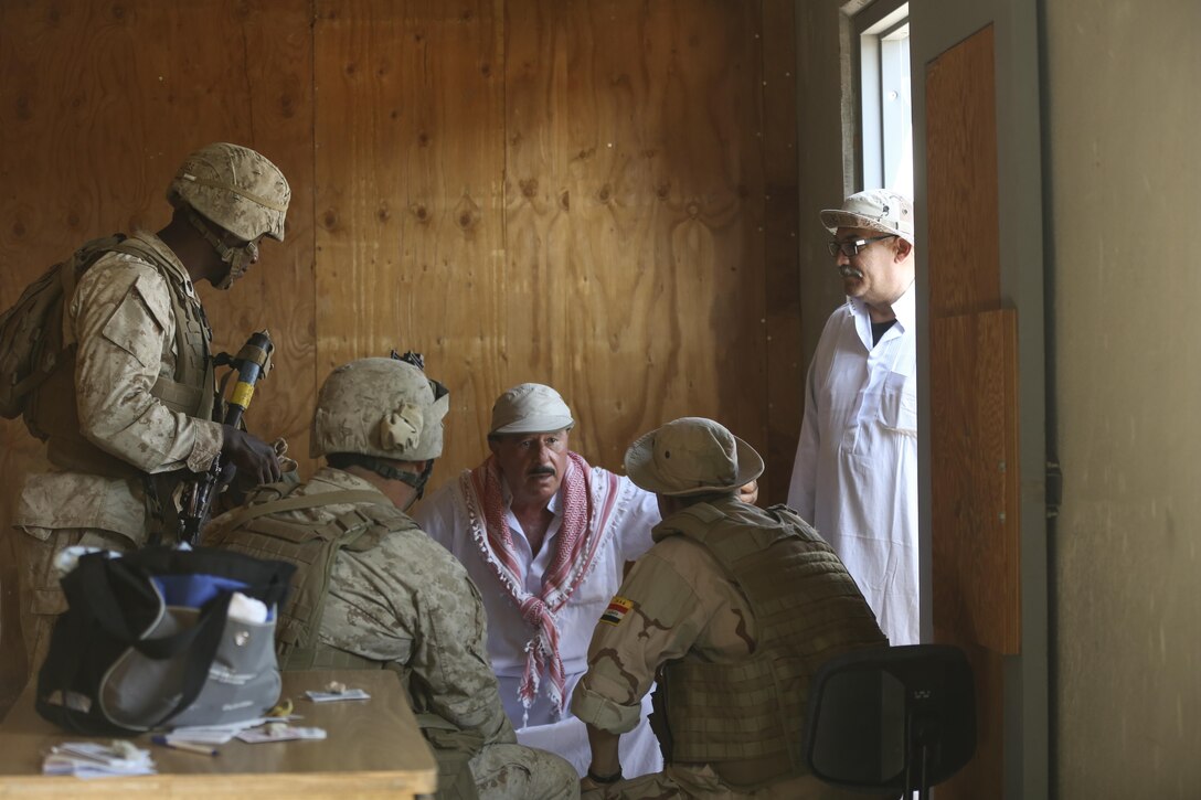 Marines with Combat Logistics Battalion 1, Combat Logistics Regiment 1, interact with a role player acting as a village elder in order to seek information about possible enemy movement in the area during Large Scale Exercise 15 aboard Marine Corps Air Ground Combat Center Twentynine Palms, Calif., Aug. 18, 2015. LSE-15 is a combined U.S. Marine Corps, Canadian and British exercise conducted at the brigade level, designed to enable live, virtual and constructive training for participating forces.