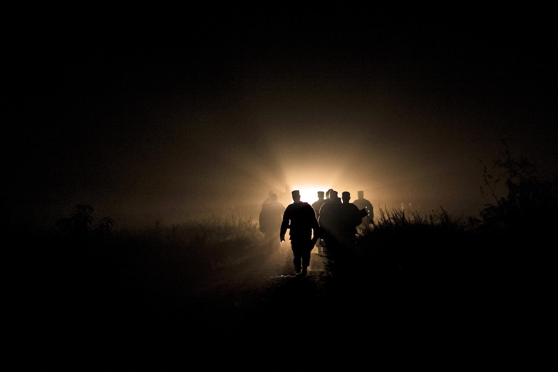 Army Reserve and National Guard combat engineer competitors march toward their Army Physical Fitness Test site to kick off their second day of Sapper Stakes 2015 in the darkness of morning on Fort Chaffee, Ark., Aug. 31, 2015. U.S. Army photo by Master Sgt. Michel Sauret