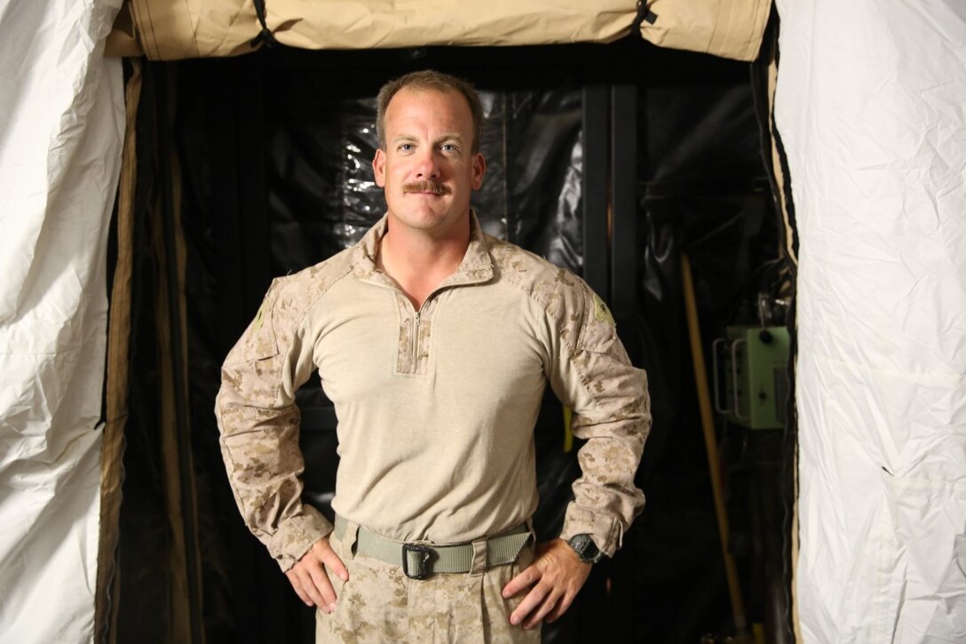 Lance Cpl. Christopher Treadwell, from Tucson, Arizona, a refrigeration technician with Task Force Al Taqaddum, poses for a photo inside a tent on Al Taqaddum Air Base Iraq, Aug. 25, 2015. Treadwell was among the first Marines to arrive at Al Taqaddum and played a crucial role in the set up and powering of the base.