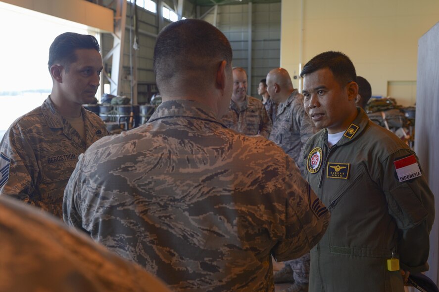 A member of the Indonesian Air Force chats with U.S. Air Force Airmen during the 2015 Pacific Agility Logistics and Safety Symposium at Yokota Air Base, Japan, Sept. 2, 2015. The symposium is a U.S. Pacific Command initiative aimed at increasing interoperability between regional partners. It allowed the multinational participants to discuss and learn innovative safety, supply and maintenance standards. (U.S. Air Force photo by Staff Sgt. Cody H. Ramirez/Released)