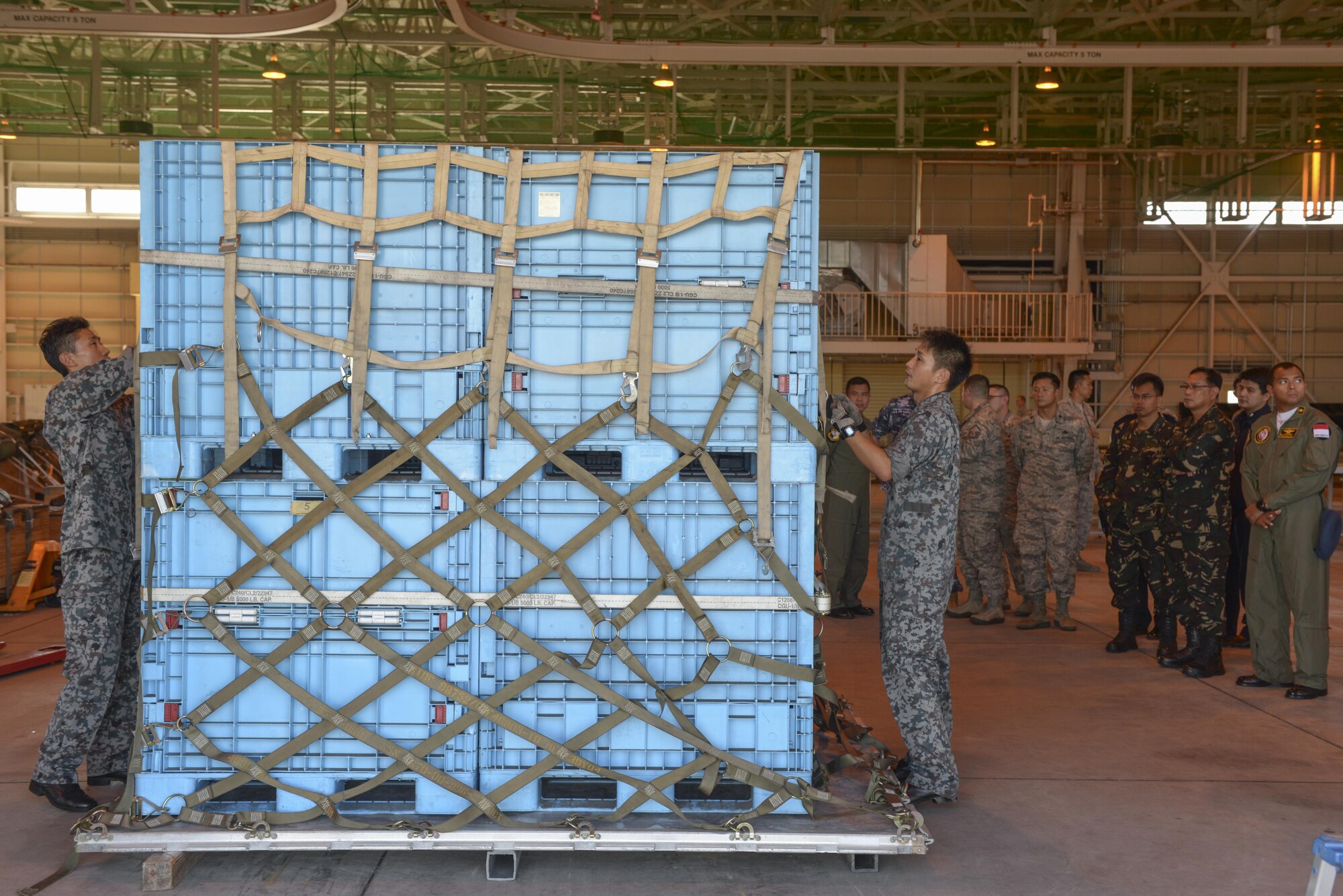 Members of the Japan Air Self-Defense Force prepare to rig a supply load using a standardized process during the 2015 Pacific Agility Logistics and Safety Symposium at Yokota Air Base, Japan, Sept. 2, 2015. The load was later processed through a U.S. cargo facility, showcasing interoperability and standardization. (U.S. Air Force photo by Staff Sgt. Cody H. Ramirez/Released)