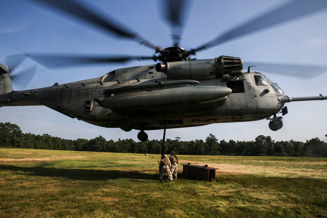A Marine with CLB-2 guides a CH-53 Super Stallion during a helicopter support team exercise at Landing Zone Albatross aboard Camp Lejeune, N.C., Sept. 2, 2015. To maintain training and readiness standards, 2nd TSB conducts HST exercises at least twice a week. (Marine Corps photo by Cpl. Tyler A. Andersen)