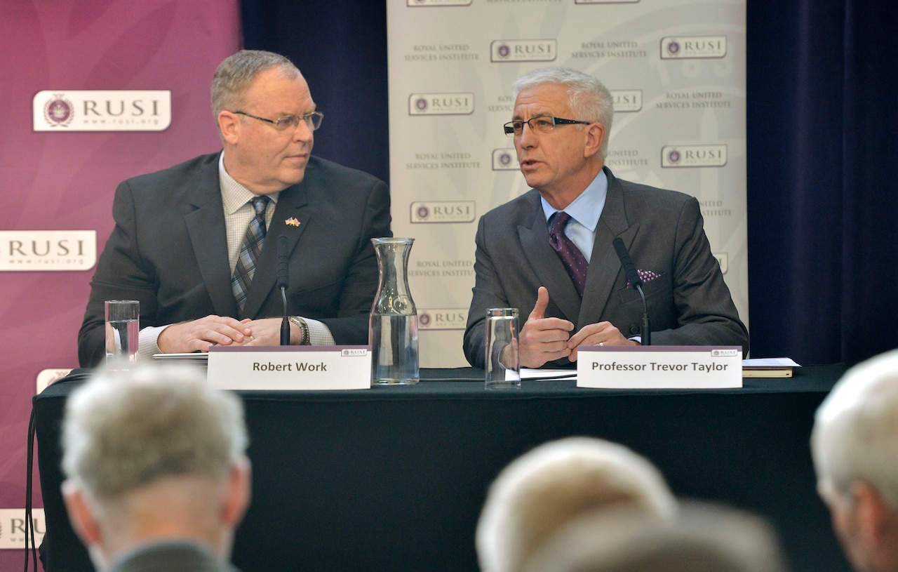 Trevor Taylor, right, professorial research fellow in defense management at the Royal United Services Institute for Defense and Security Studies, introduces U.S. Deputy Defense Secretary Bob Work, who delivered remarks to institute members in London, Sept. 10, 2015. DoD Photo by Glenn Fawcett