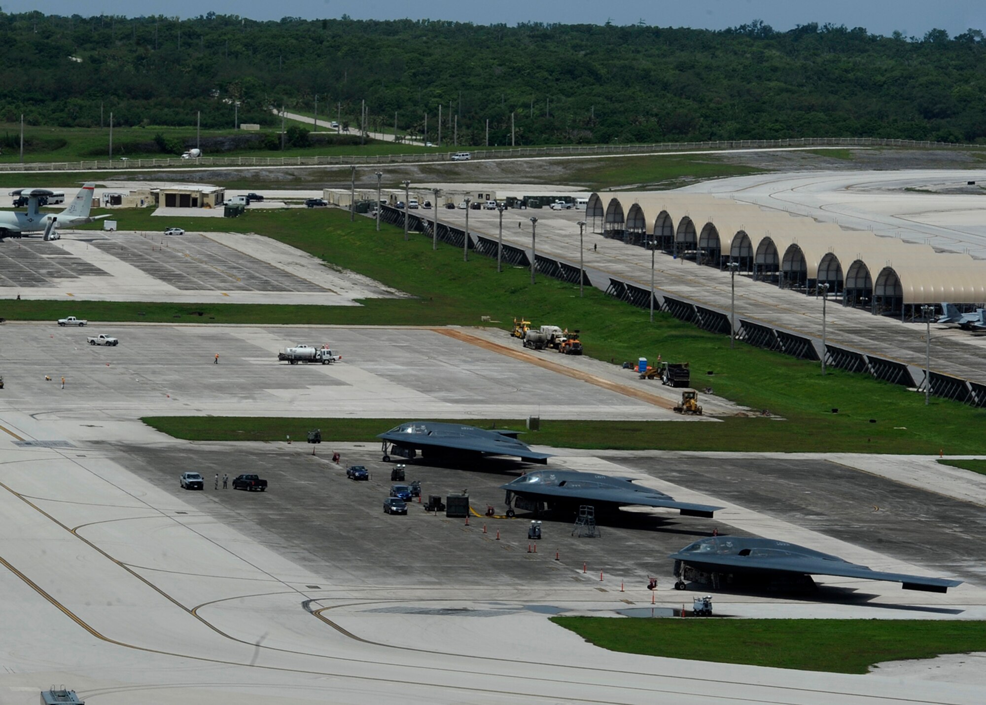 Three B-2 Spirit bombers from Whiteman Air Force Base, Mo., are parked on the flightline at Andersen Air Force Base, Guam, Aug. 25, 2015. Whiteman deployed approximately 225 Airmen and three aircraft here to conduct familiarization training in the Indo-Asia-Pacific region. (U.S. Air Force photo by Senior Airman Joseph A. Pagán Jr./Released)