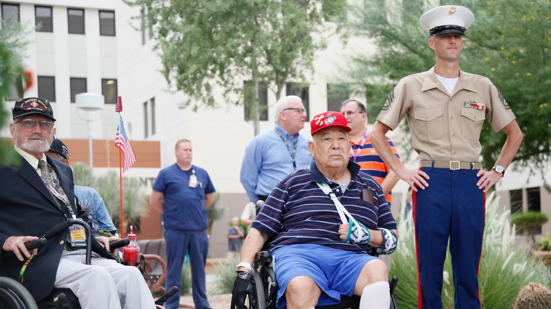 Marines, veterans and care providers watch as the American flag is walked to the flagpole at the Carl T. Hayden VA Medical Center in Phoenix, Sept. 10, 2015. Marine Week Phoenix is a chance to reconnect with our Marines, sailors, veterans and their families from different generations.