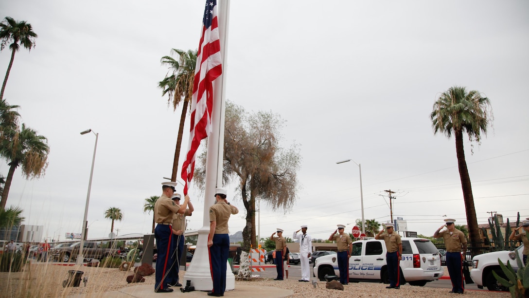 Marines and a sailor salute the American flag during the “National Anthem” at the Carl T. Hayden VA Medical Center, Phoenix, Sept. 10, 2015. Marine Week Phoenix is a chance to reconnect with Marines, sailors, veterans and their families from different generations.