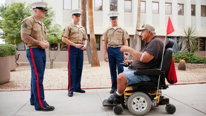Marines listen to a veteran share his story during their visit to the Carl T. Hayden VA Medical Center, Phoenix, Sept. 10, 2015. Marine Week Phoenix is a chance to reconnect with Marines, sailors, veterans and their families from different generations.