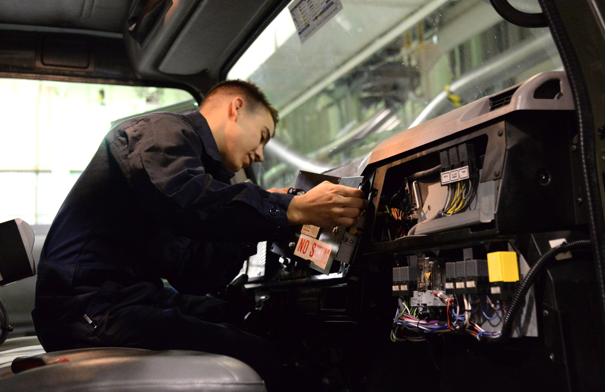 U.S. Air Force Senior Airman Steven Venegas, a 354th Logistics Readiness Squadron firefighting and refueling vehicle and equipment maintenance journeyman, takes apart a dashboard, Sept. 10, 2015, at Eielson Air Force Base, Alaska. Venegas preforms troubleshooting procedures while completing routine maintenance on a refueling truck. (U.S. Air Force photo by Airman 1st Class Cassandra Whitman/Released)