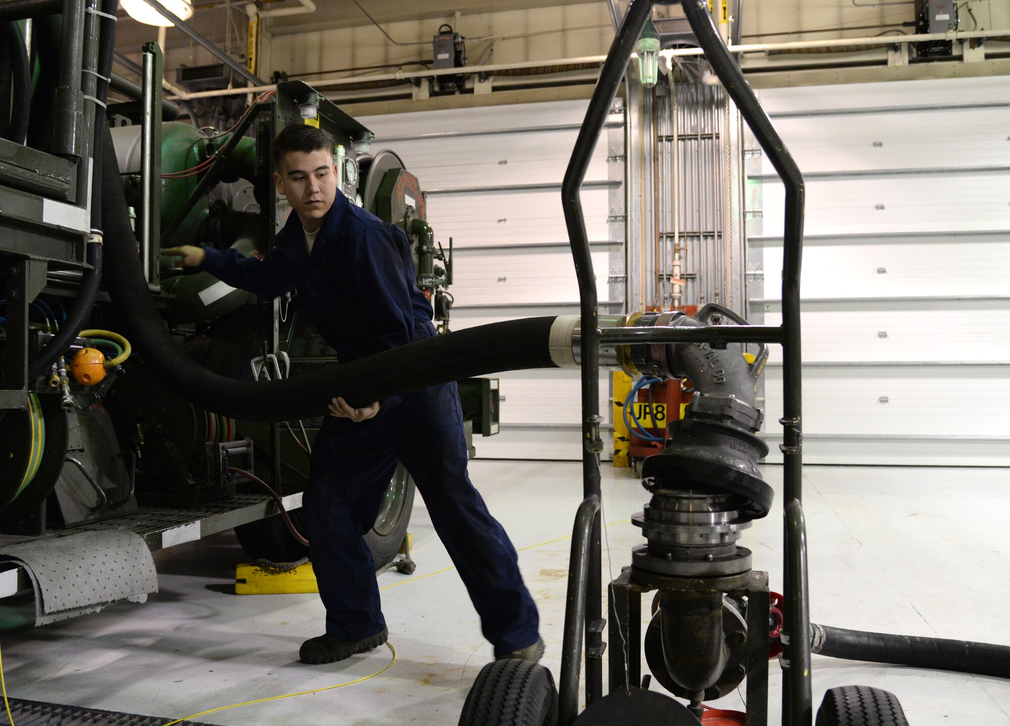U.S. Air Force Senior Airman Steven Venegas, a 354th Logistics Readiness Squadron firefighting and refueling vehicle and equipment maintenance journeyman, hooks up a fuel pump, Sept. 10, 2015, at Eielson Air Force Base, Alaska. Venegas needs the pump put together in order to perform troubleshooting procedures while completing routine maintenance on the truck. (U.S. Air Force photo by Airman 1st Class Cassandra Whitman/Released)