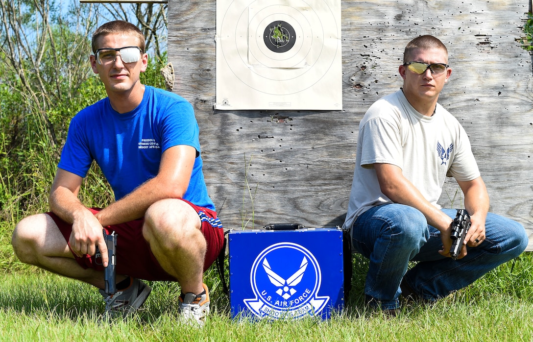 U.S. Air Force Staff Sgt. Jeremiah Jackson, (right), 23d Equipment Maintenance Squadron aircraft metals technology craftsman, and Senior Airman Ian Pitts, 23d EMS munitions flightline delivery crew chief, pose for a photo after pistol shooting practice Sept. 4, 2015, in Valdosta, Ga. Jackson, a member of the Air Force’s National Pistol Team, took Pitts underneath his wing as his protégé to help him perfect his pistol shooting techniques in preparation for team camp.  (U.S. Air Force photo by Senior Airman Ceaira Tinsley/Released)